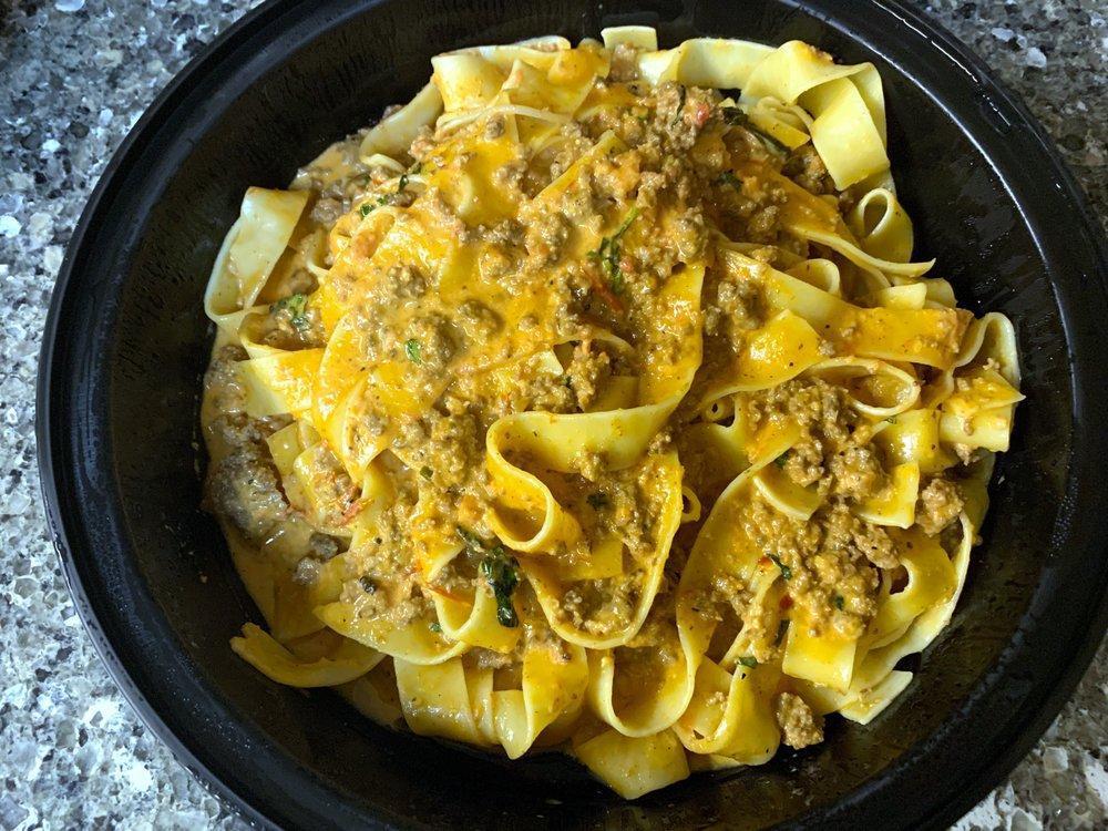 Fettuccine Bolognese · Egg noodles tossed in a creamy meat ragu, topped with fresh basil and Parmesan cheese.
