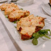 Crab Bruschetta · 4 pieces. Char-grilled Italian bread, creamy crabmeat, roasted red peppers, Parmesan cheese,...