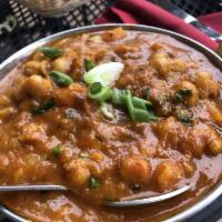 Chana Masala · A zesty favorite with chickpeas cooked in masala sauce.