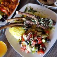 Grilled Lamb Chops · Grilled with olive oil, lemon, garlic, rosemary, served with seasoned rice, a salad of tomat...