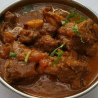 Goat Curry · Goat meat with bone specially cooked in onion, tomato, and traditional spices from Nepal.