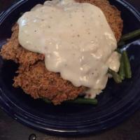 Chicken Fried Steak · A crisp 6 oz. breaded sirloin served with garlic whipped potatoes, green beans and cream gra...