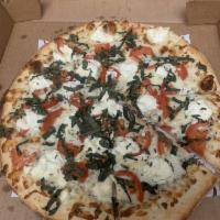 Margarita Pizza · White sauce, mozzarella cheese, vine tomatoes, ricotta cheese and fresh basil.