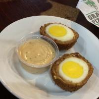 Scotch Egg · A hard boiled egg wrapped in Italian sausage then breaded and fried. Served with chipotle ra...