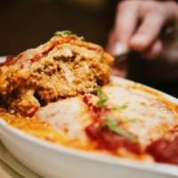 Lasagna · Specialita dello chef. Chef's specialty. Baked layers of ground veal, ricotta, mozzarella an...