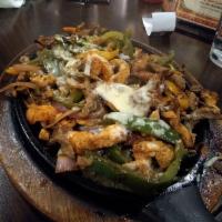Flaming Cheese Fajitas · Grilled strips of chicken and steak, covered with flaming melted cheese.