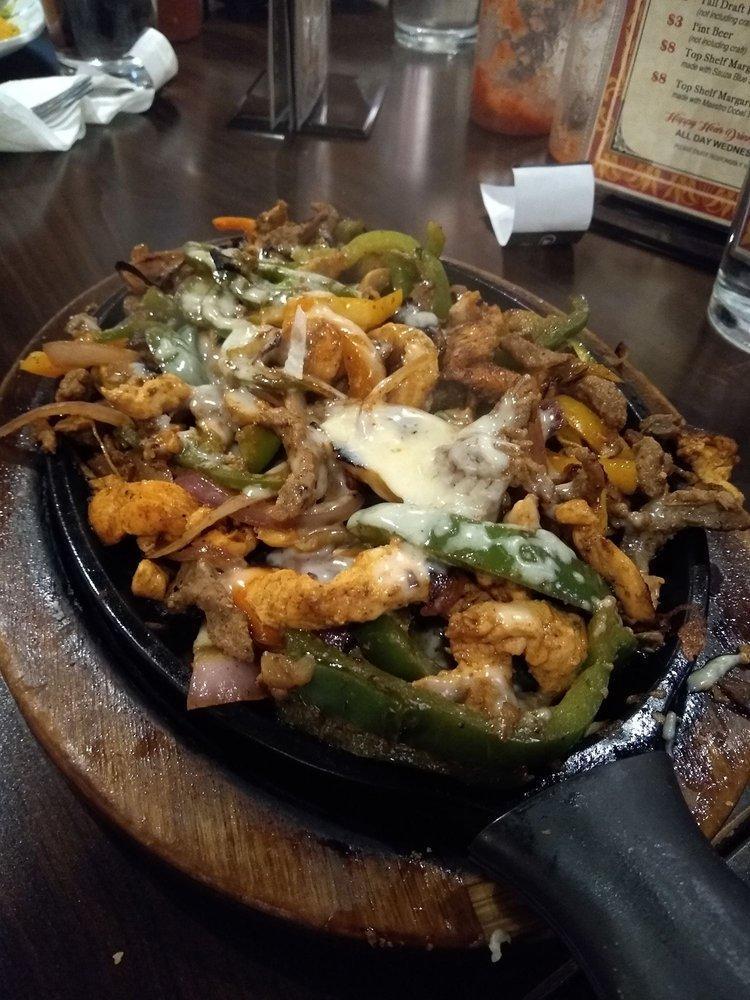 Flaming Cheese Fajitas · Grilled strips of chicken and steak, covered with flaming melted cheese.