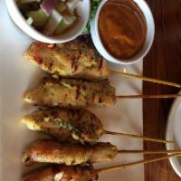 Chicken Satay · Grilled chicken skewers served with cucumber salad and peanut sauce.  