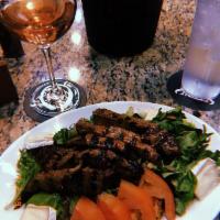 Marinated Steak Salad · Grilled prime beef steak with mixed greens, tomatoes toasted pumpkin seeds chi spiced onion ...