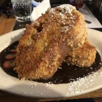 Vegan French Toast · Fresh baked ciabatta bread dipped in a banana coconut batter. Topped with powder sugar, and ...