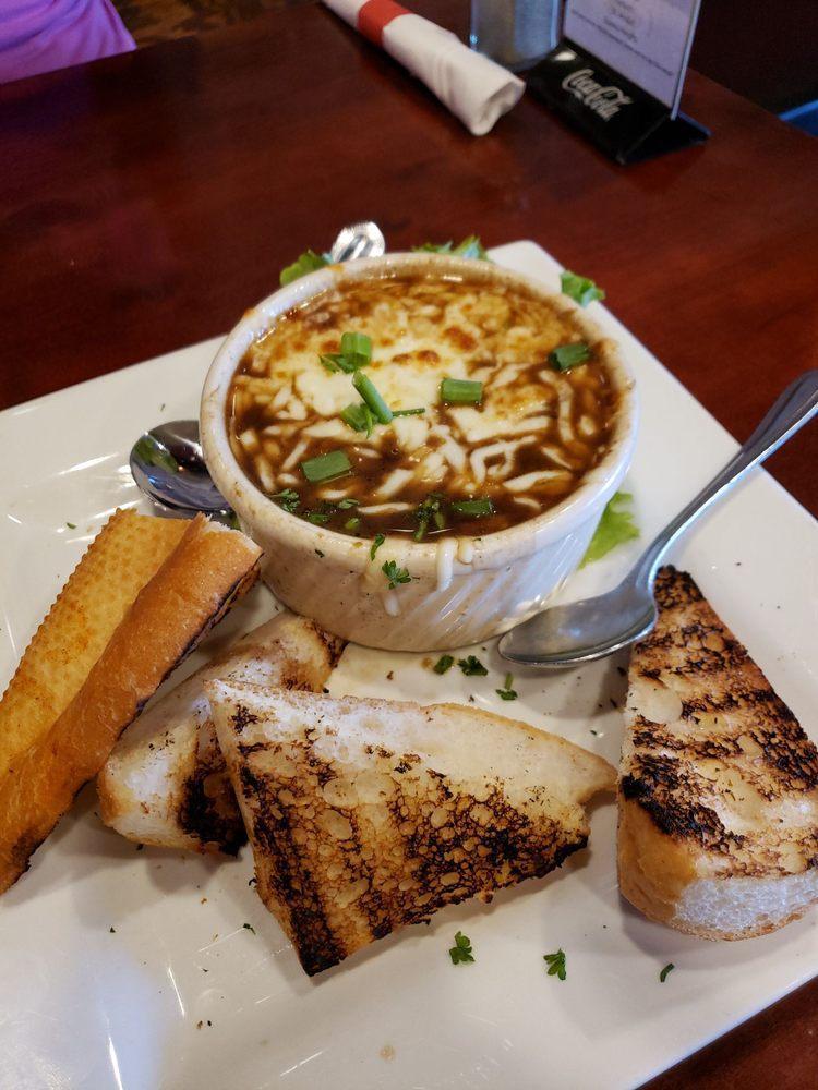 French Onion Soup · Sweet onion and red wine broth combined with house made croutons topped with provolone and mozzarella cheese and served with toasted baguette.
