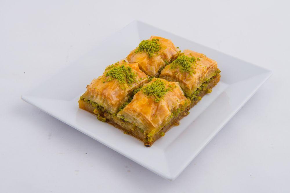 Baklava · Sweet pastry made of extremely thin sheets of phyloo dough layer with chopped nuts and honey syrup baked with butter and cut into diamonds. 