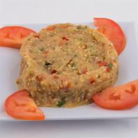 Eggplant Salad · Char-grilled eggplant mashed and tossed with tomatoes, onions, peppers, and olive oil.