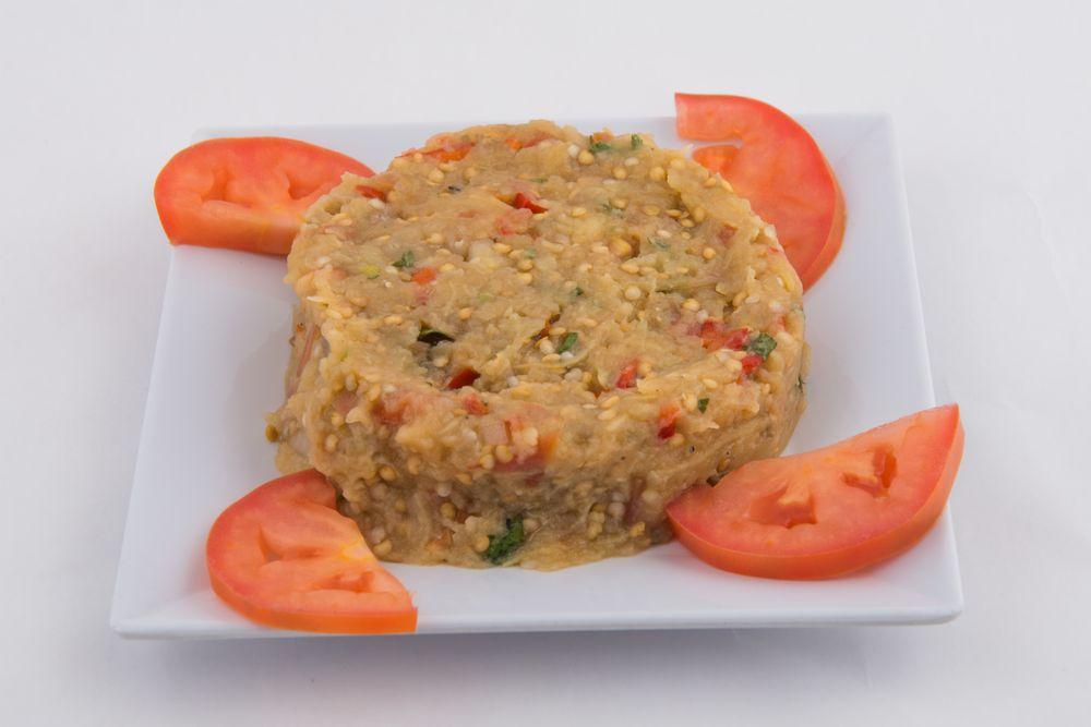Eggplant Salad · Char-grilled eggplant mashed and tossed with tomatoes, onions, peppers, and olive oil.