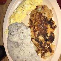 Country Scramble · Biscuit, sausage gravy, 2 scrambled eggs and home fries.
