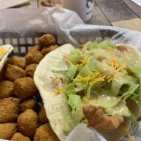 Fish Tacos · Two tacos loaded with fish topped with lettuce, cheese and your choice of sauce