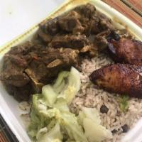 Curry Goat · Served with fried plantains, veggies, and white rice or rice and peas. Spicy.