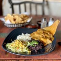 Tamales · 2 pork tamales and mean green chile. Served with black beans and cilantro lime rice. Lettuce...