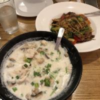Tom Kha · Coconut milk soup with lemongrass, galangal, kaffir lime leaves, cilantro, green onion and m...