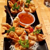 Crab Rangoon Appetizer · Crispy wonton filled with Dungeness crab meat, cream cheese, water chestnut, onion and carro...