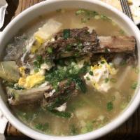 Galbi Tang · Beef short rib soup with glass noodles and garnish.