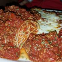 Chicken Parmigiana · Breaded chicken breast topped with tomato sauce and mozzarella. Comes with bread and side pa...