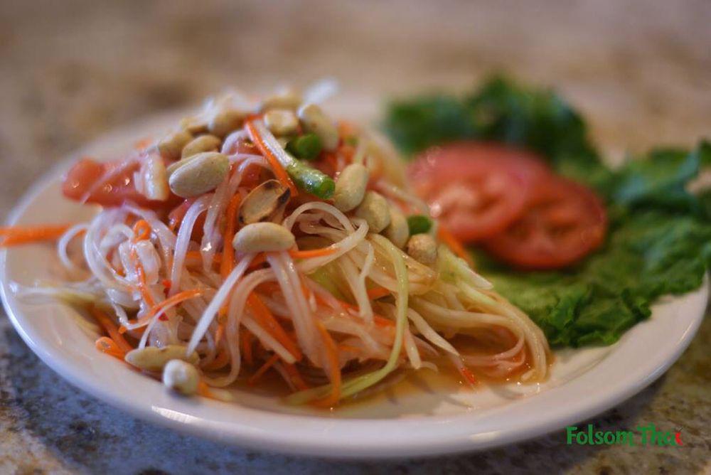 Papaya Salad · Shredded green papaya with carrots, tomatoes, green beans and peanuts in spicy, sweet and sour lime juice sauce.