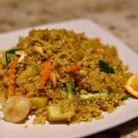 Pineapple Fried Rice · Stir-fried rice with egg, curry powder, cashew nuts, pineapple, carrots, and onions.