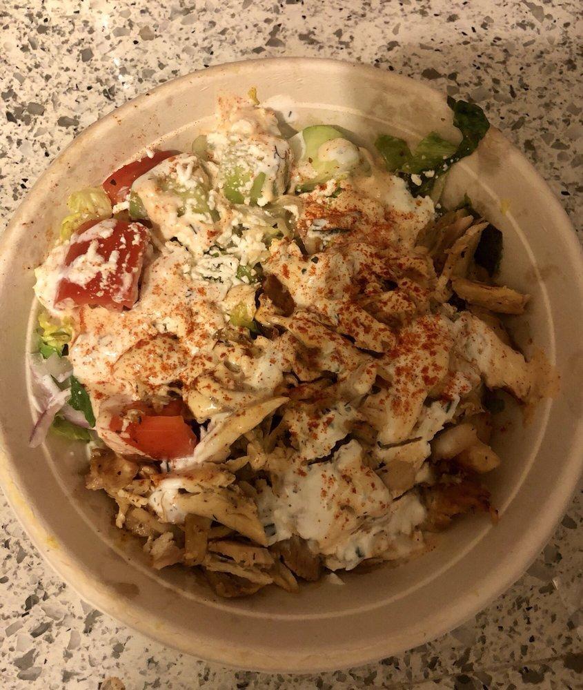Gyro Bowl · Choice of any meat or falafel, basmati rice, romaine lettuce, onions, tomatoes, English cucumbers, feta and red wine vinaigrette topped with tzatziki and spicy yogurt. Add extras for an additional charge.