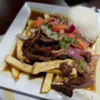 Lomo Saltado · Tender beef strips, onions and tomatoes sauteed and seasoned in our fire woks. Served with f...