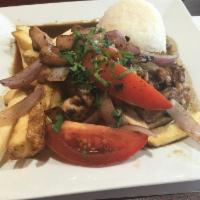 Pollo Saltado · Chicken, onions, tomatoes and french fries sauteed and seasoned in our fire woks. Served wit...
