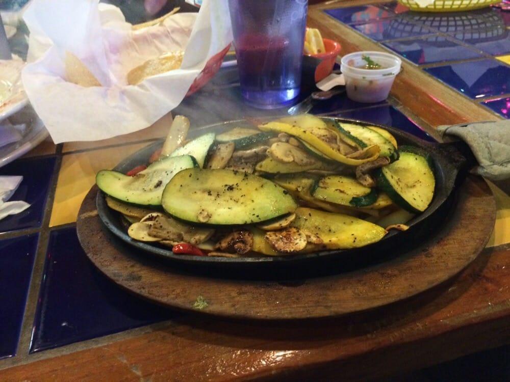 Veggie Fajitas · Grilled zucchini, squash, onions, bell peppers, and mushrooms. Served with cilantro lime rice, black beans and either warm tortillas or crisp lettuce leaves.