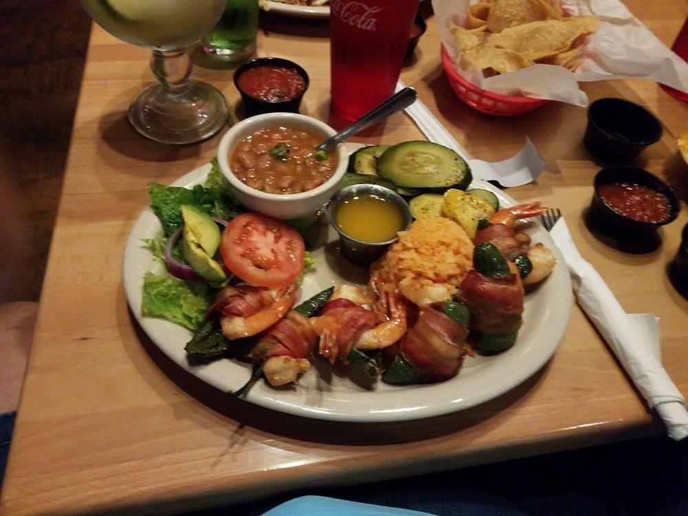 Cabo Shrimp · 6 piece butterflied jalapeno shrimp wrapped in bacon, cooked in lemon garlic butter and served over Mexican rice. Served with grilled veggies, avocado slices and lemon garlic butter for dipping.