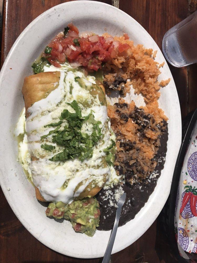 Chimichanga · Flour tortilla, filled with Meat Choice*, refried black beans, rice, onions, cheese, then deep-fried. Topped with sour cream, cilantro and cotija cheese. Served with rice, refried beans, pico de gallo and guacamole on the side.