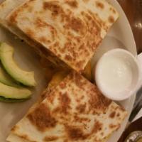 Quesadilla · Ten-inch flour tortillas with jack and cheddar cheese in the middle. Sour cream and avocado ...