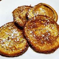 Cinnamon French Toast · Four slices dusted with powdered sugar.