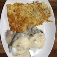 Southern Benedict Breakfast · A split buttermilk biscuit topped with sausage patties, poached eggs and creamy sausage grav...