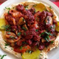 Spicy Sausage Hummus Specialty · Sauteed Armenian sujuk with tomatoes and fresh mushrooms.