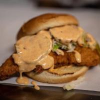 The Crispy Chicken Sandwich · Our house battered chicken sandwich with coleslaw, pickles and honey aioli.