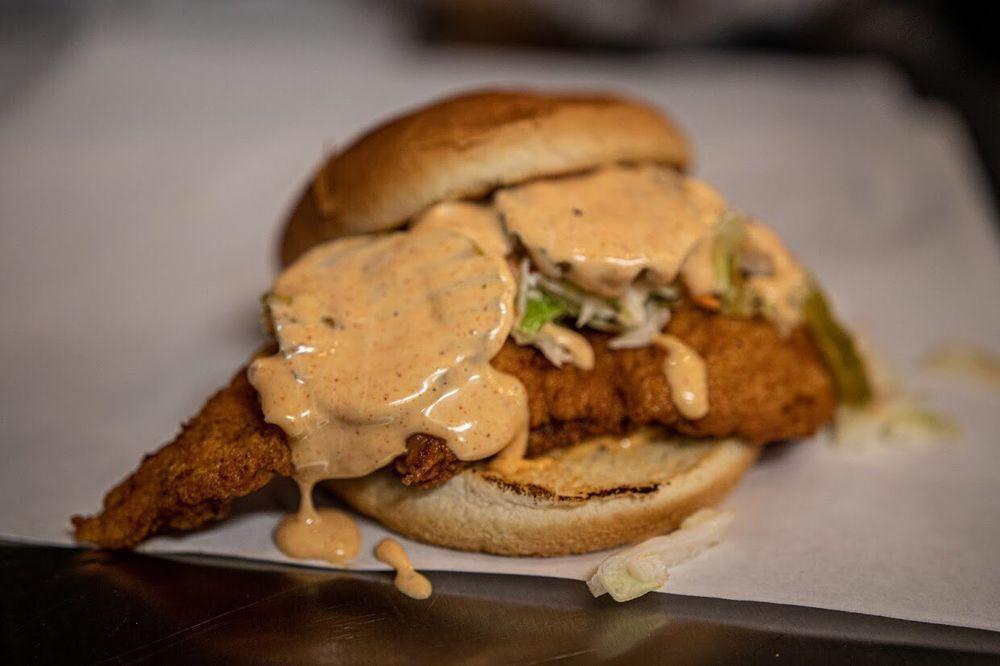The Crispy Chicken Sandwich · Our house battered chicken sandwich with coleslaw, pickles and honey aioli.
