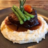 Filet Mignon · Center cut of beef filet mignon served with French beans over cheesy mashed potatoes with mu...