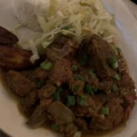 Curried Goat · Served with jasmine rice, sautéed cabbage and sweet plantains.