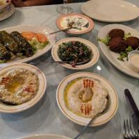 Mezza · Hommos, tabbouleh, baba ghanouj, falafel labneh and grape leaves. 