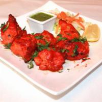 Tandoori Chicken ·  Chicken leg quarter marinated in Indian spices and finished in tandoor.