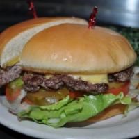 Cheeseburger · Old fashioned cheeseburger with American cheese, lettuce, tomato, pickles, onion on a grille...