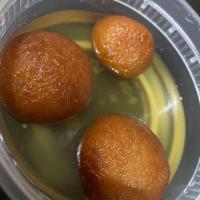 Gulab Jamun · Cheese and reduced milk balls deep fried and soaked in saffron flavored sugar syrup and serv...