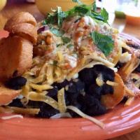 Masa Nosh · Our nachos. House-made tortilla chips topped with verde sauce, crema, black beans, smoky que...