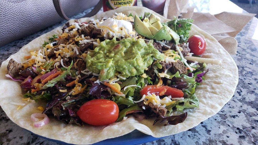 Adobe Salad · Mixed salad, corn, jicama, red onions, black beans, cheese, tomatoes, sour cream and guacamole, on a warm flour tortilla with Southwest vinaigrette.