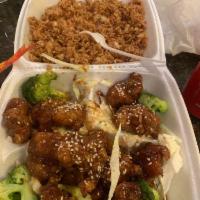 Sesame Chicken · Deep fried chicken stir fried with sesame sauce with steamed broccoli. Served with steamed o...