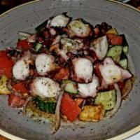 Grilled Octopus Salad · Grilled octopus, Roma tomatoes, cucumber, red onions, fresh squeezed lemon juice, EVOO, oreg...